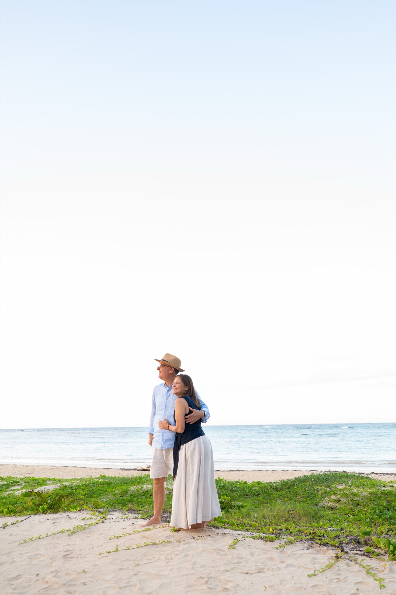 A couple embracing on the shore at golden hour