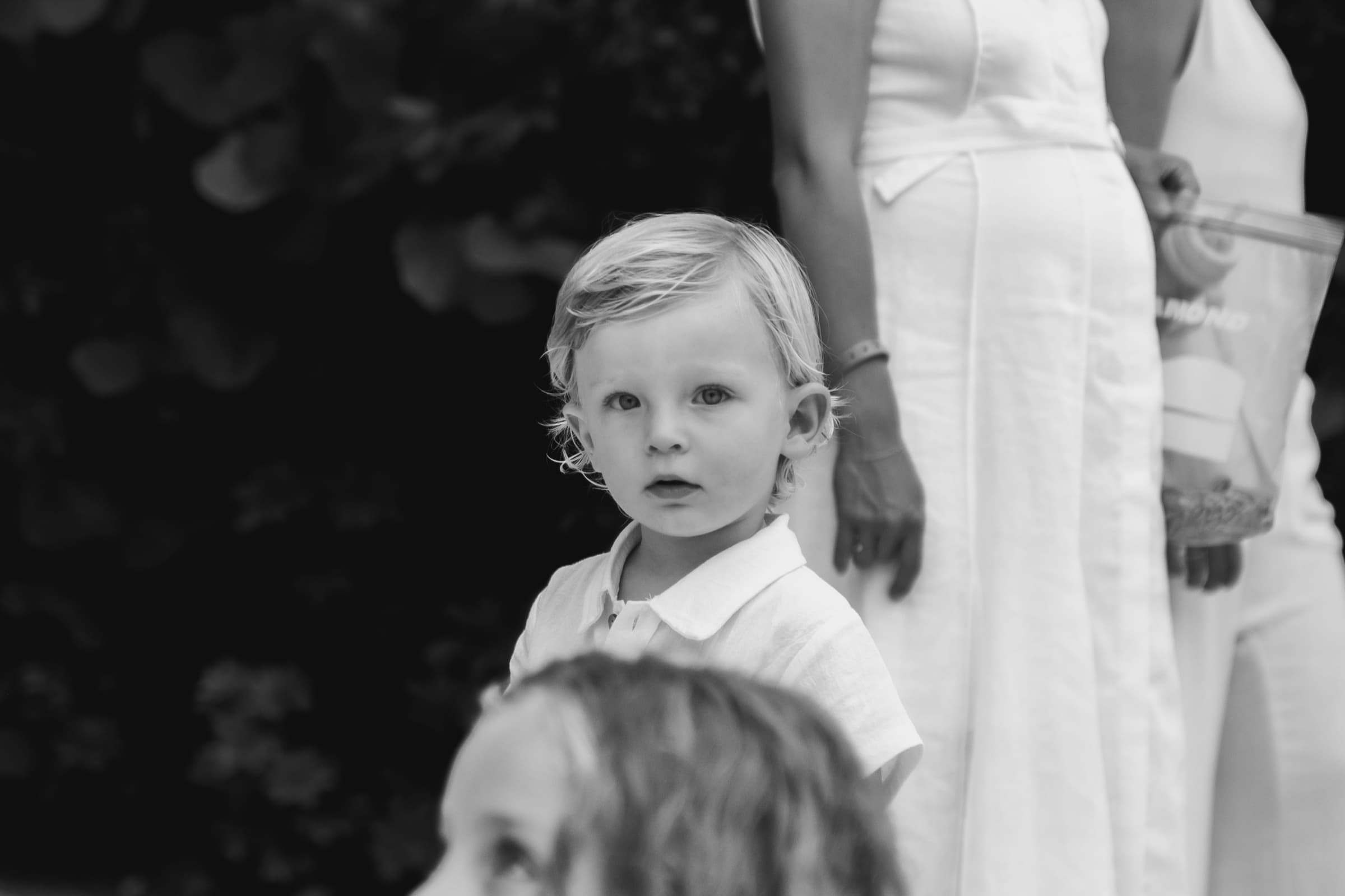 A candid portrait of a toddler, unposed, black and white