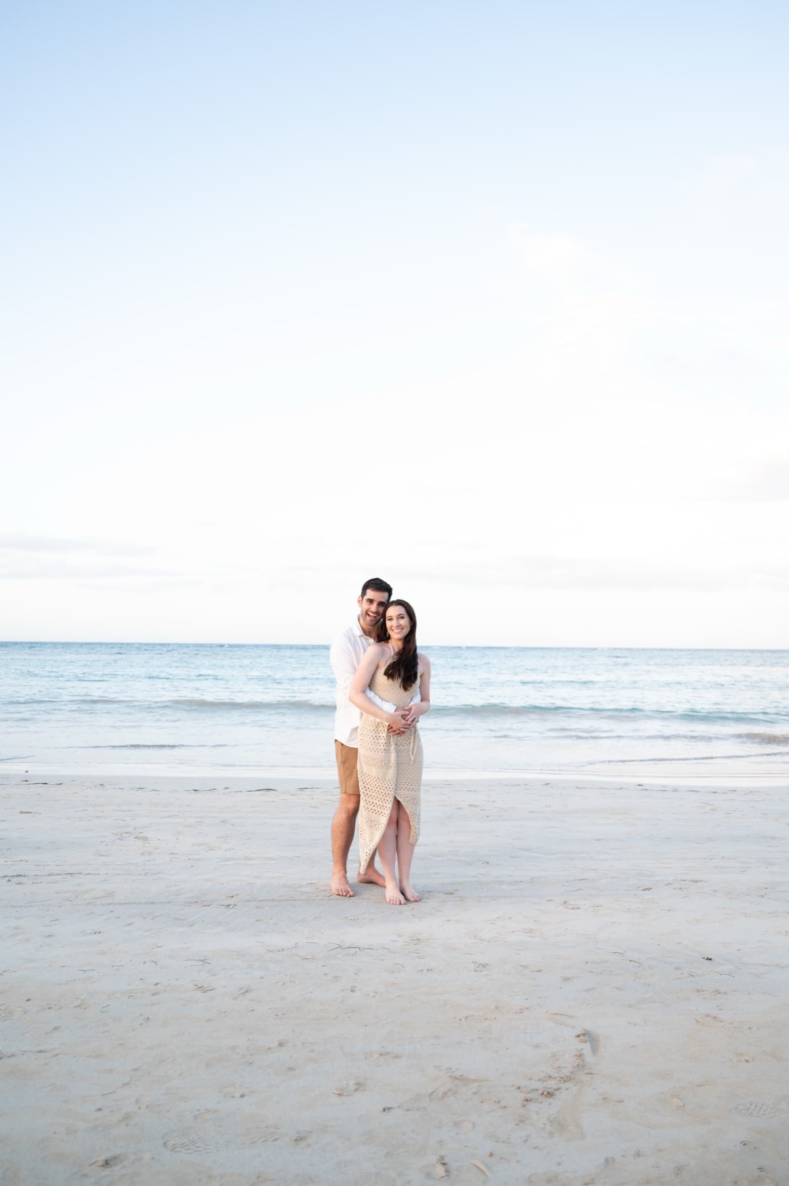 A couple embracing on the beach at golden hour