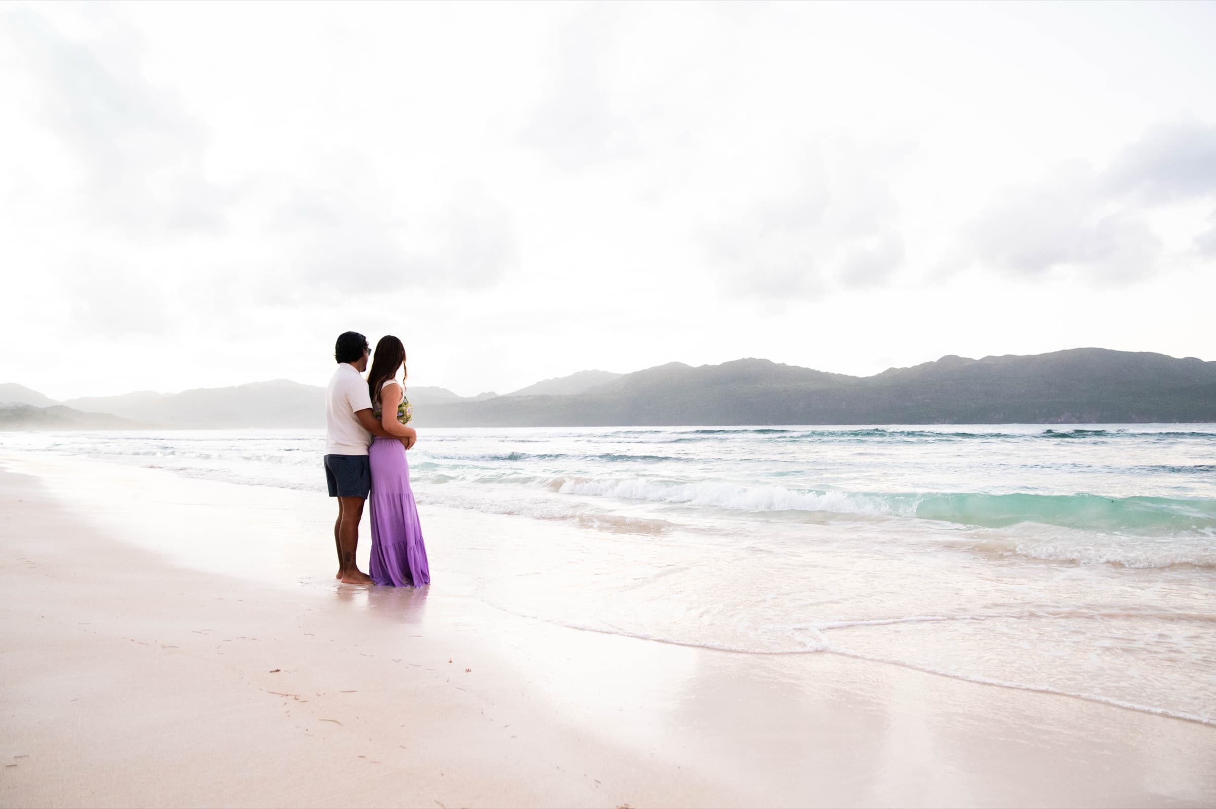 Alana & Rodrigo, standing in the waves