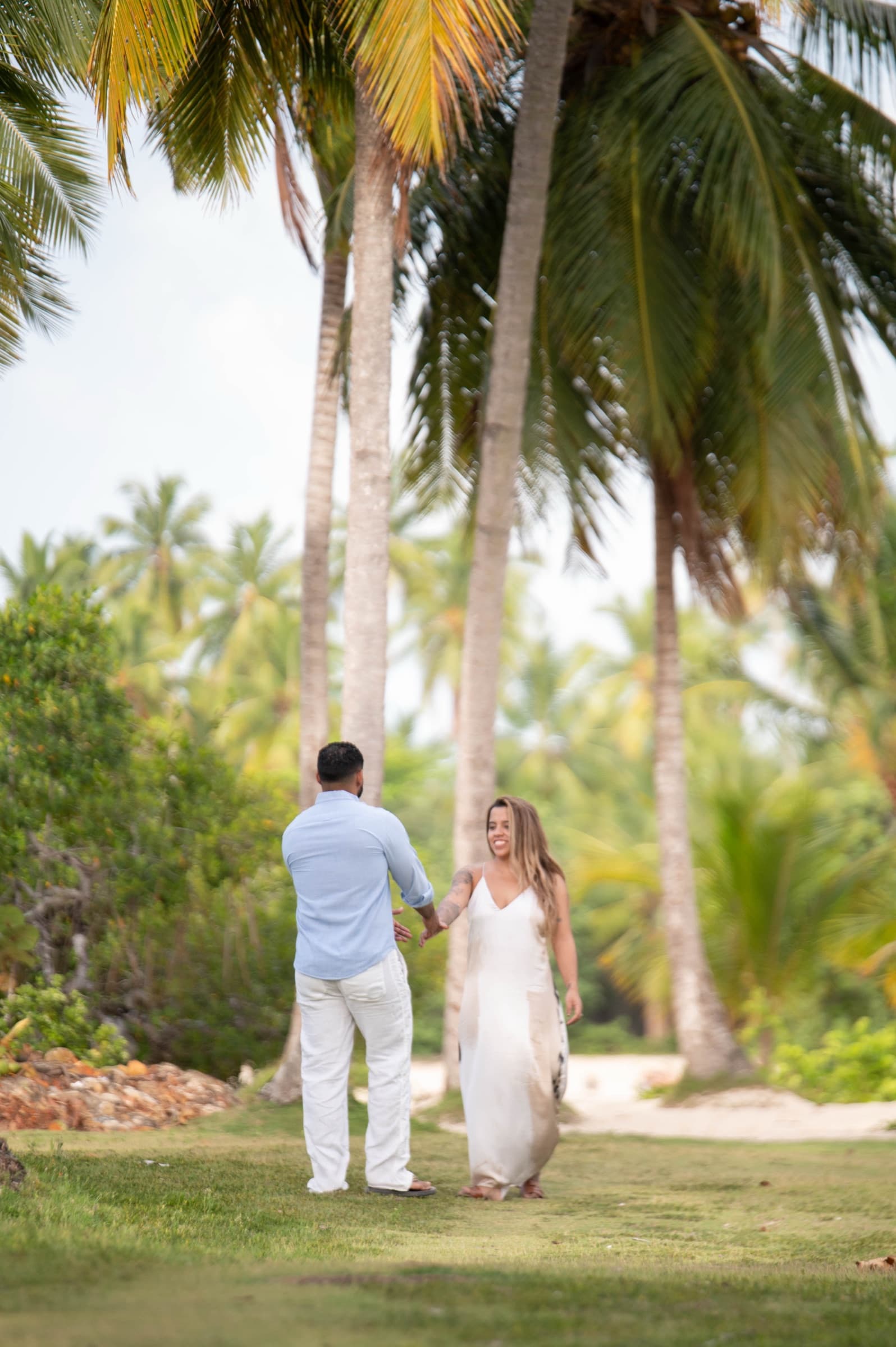 Mari & Ramses walking beneath the palms