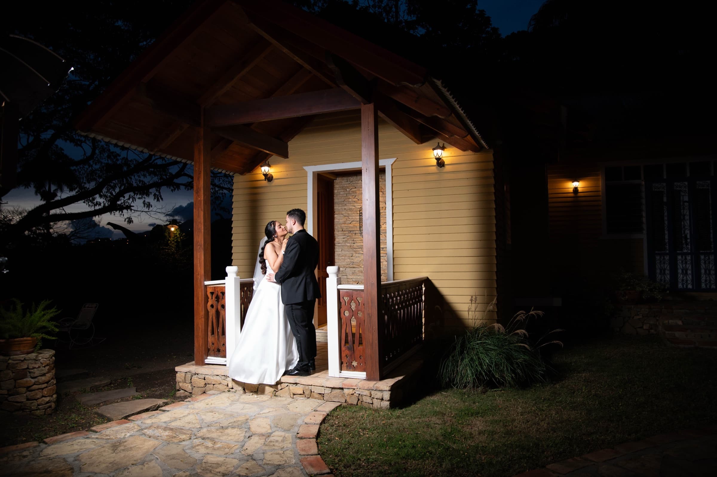 Zeta & Daniel sharing a kiss at night on their wedding day