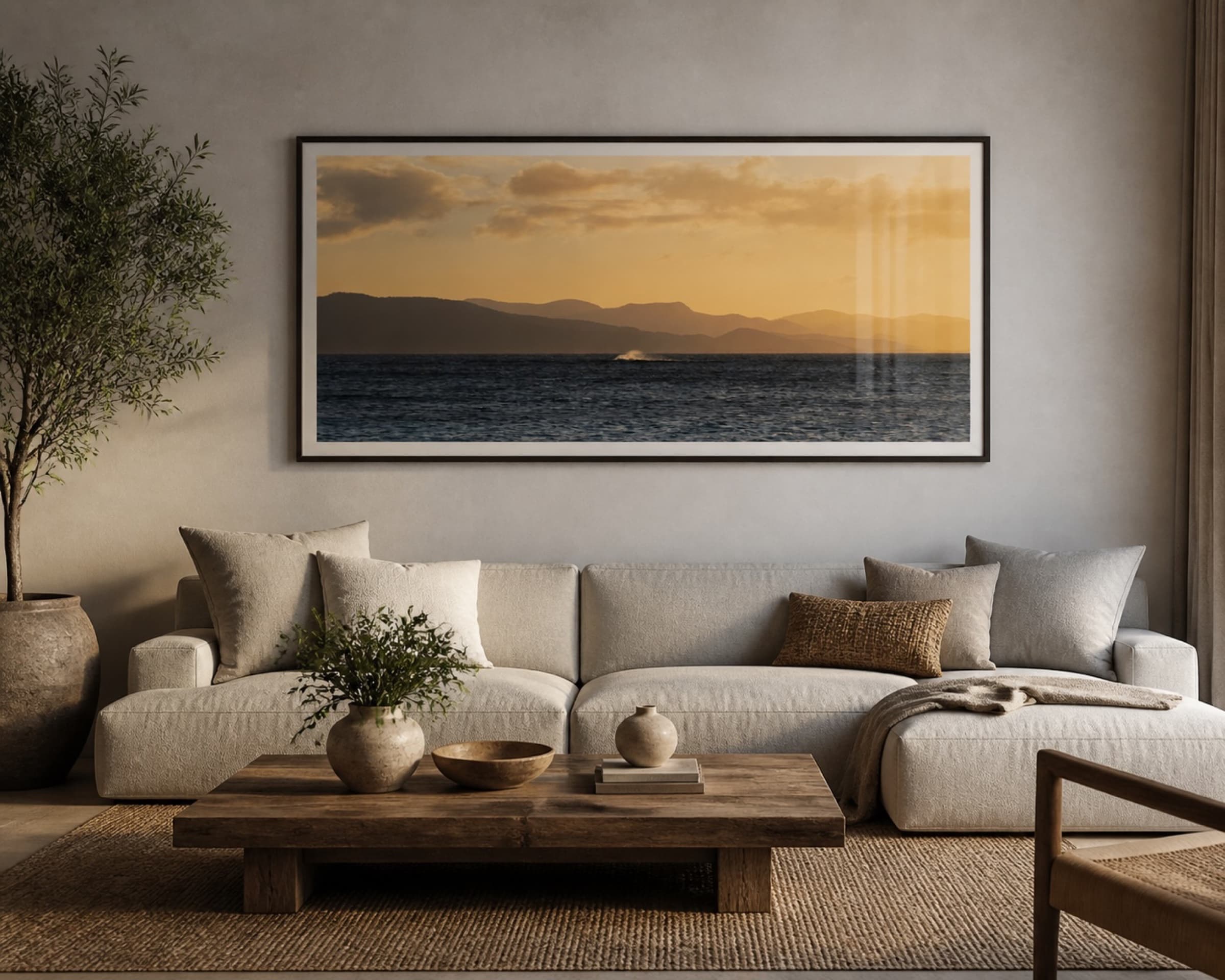Framed panoramic sunset print above a living room sofa